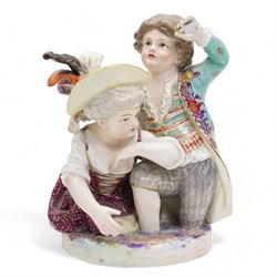 Meissen porcelain group modelled as two cherubs playing with a goat, the oval scroll moulded base heightened in gilt, blue crossed swords, inscribed no. 2454, H10cm, together with a Meissen figure of a young girl and boy, possibly emblematic of autumn, unmarked, (2) Provenance: From the Estate of the late Dowager Lady St Oswald