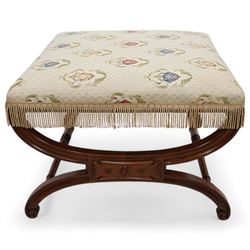 Regency mahogany stool, square seat upholstered in ivory ground floral patterned fabric with gilt thread and fringing, raised on a curved X-framed base united by ring turned supports