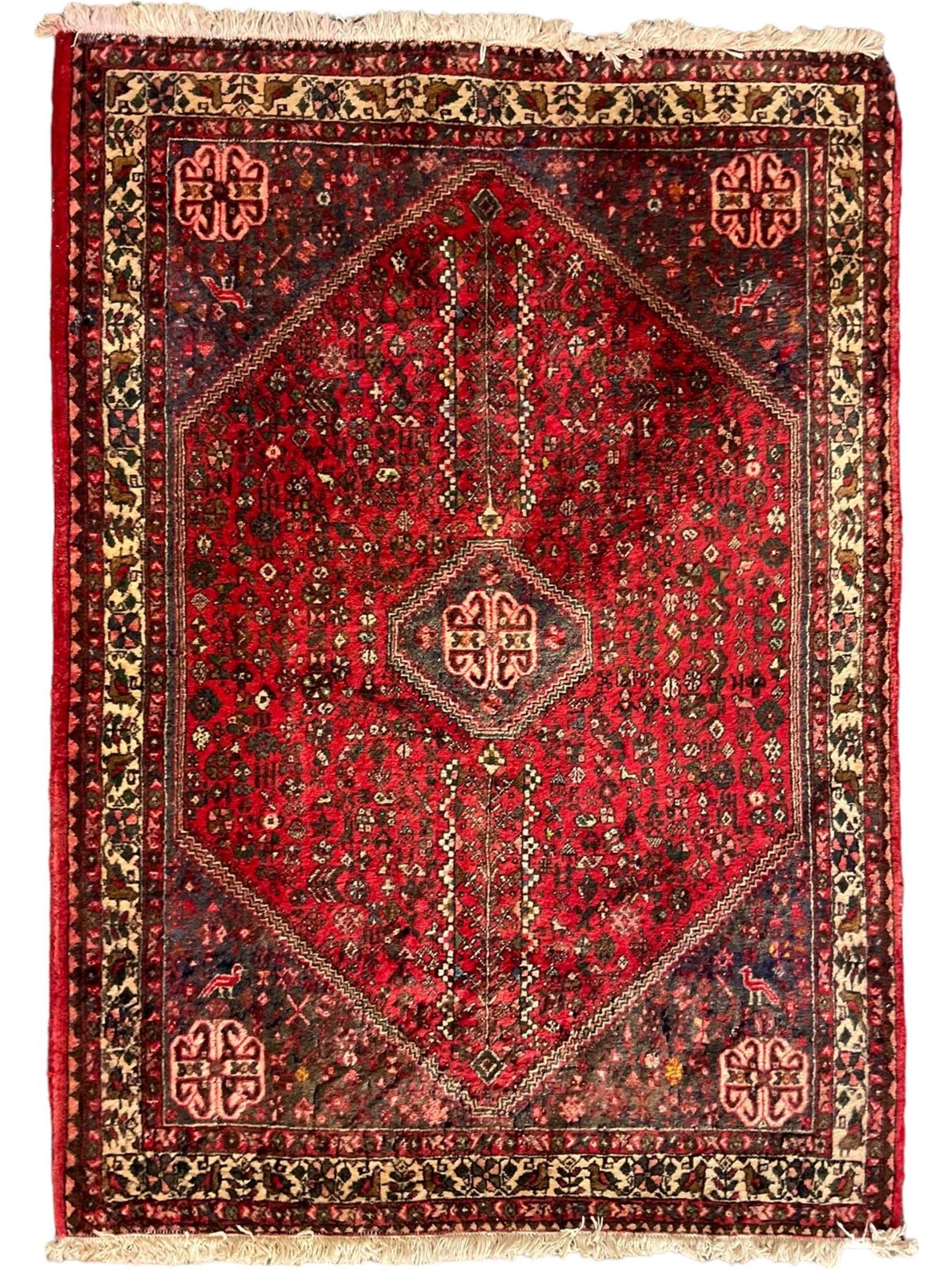 Persian Kashan crimson ground rug, hexagonal field decorated with central medallion and surrounding bird plant and animal motifs, guarded border with repeating floral and bird design