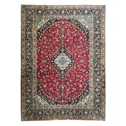 Persian Kashan crimson ground carpet, the central pole medallion decorated with flower hea...