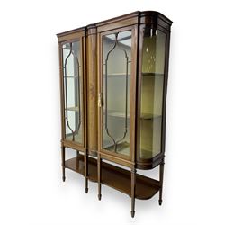 Edwardian inlaid mahogany display cabinet, projecting moulded cornice over two glazed door...