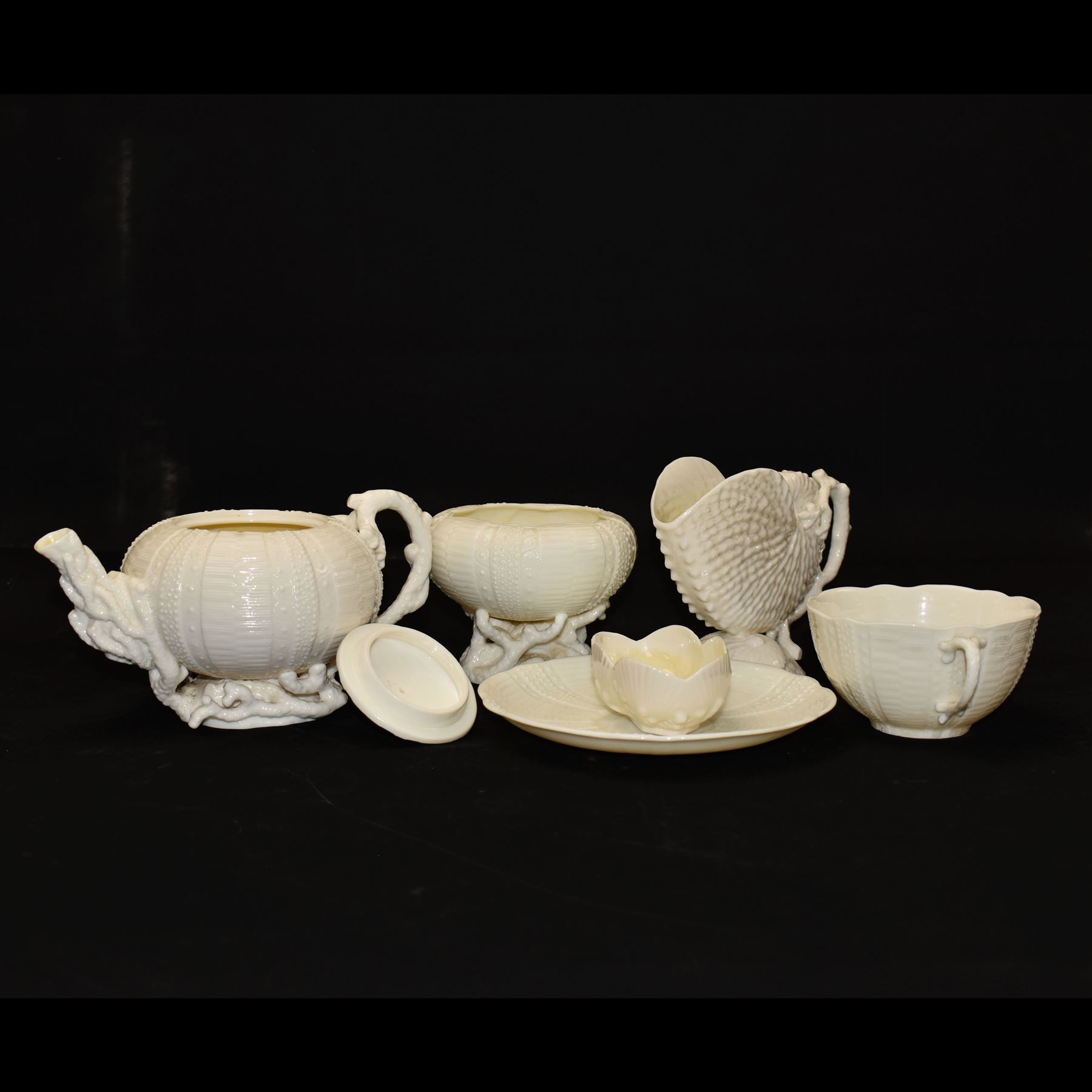 Belleek Sea Urchin teapot and sugar basin, together with Belleek Nautilus jug, small dish, teacup and saucer