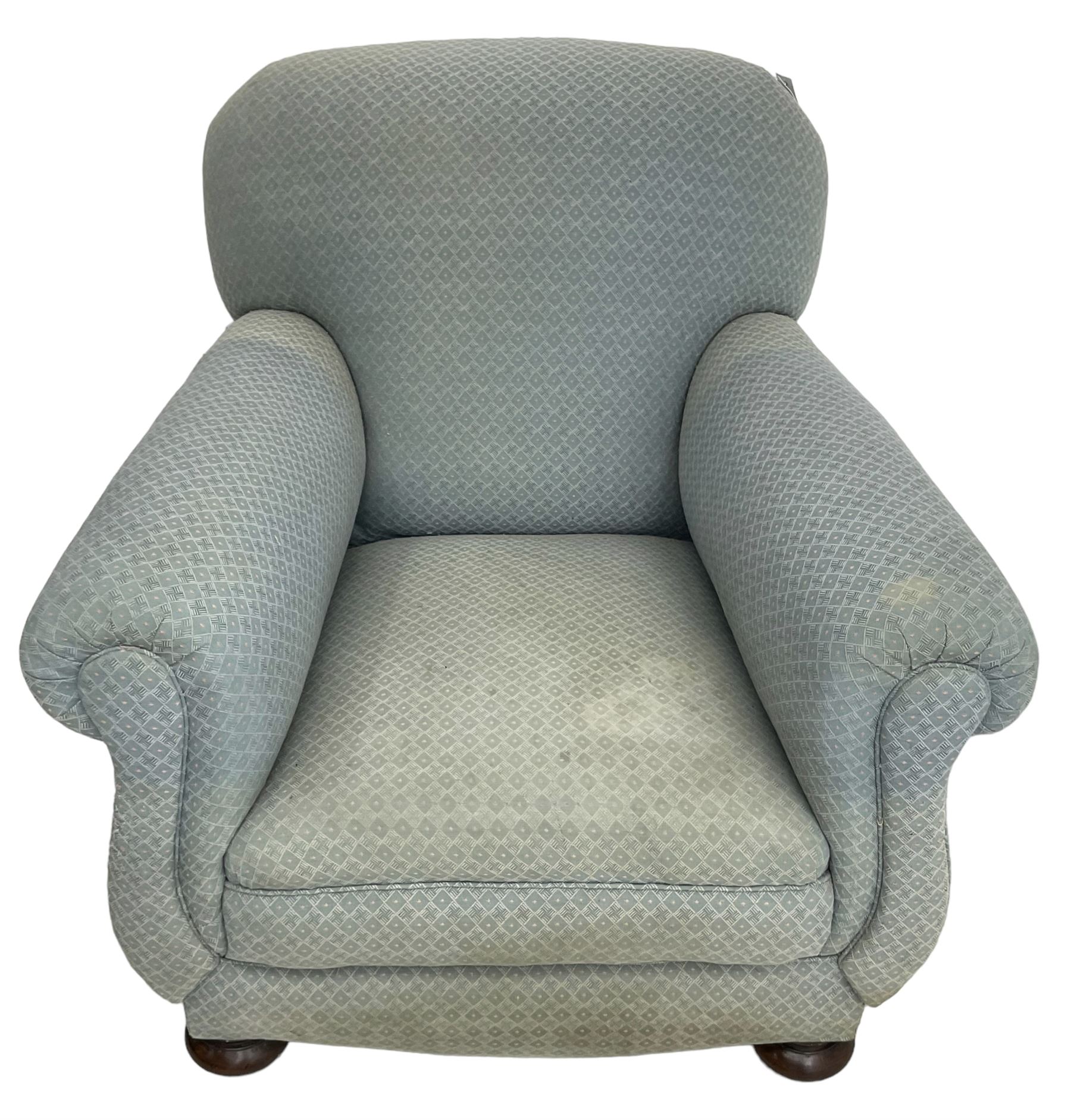 20th century traditional shape armchair, curved back and rolled arms, upholstered in light blue patterned fabric, on turned front feet