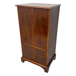 Wade - yew wood hi-fi cabinet, moulded rectangular hinged top over double-door cupboard with figured veneer, enclosing three adjustable shelves, lower section fitted with two cupboards to resemble four drawers, enclosing three drawers and open storage