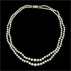 Early 20th century double strand, graduating pearl necklace, with 15ct and palladium milgr...