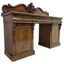 Victorian mahogany twin pedestal chiffonier, raised back with decorated with scrolling foliate motifs, fitted with three cushion drawers, the arched panelled pedestals enclosing shelves and sliding trays