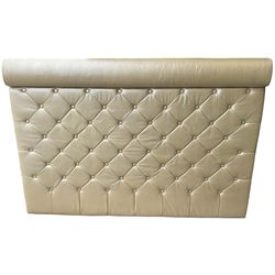 Large padded headboard, upholstered in beige buttoned faux leather