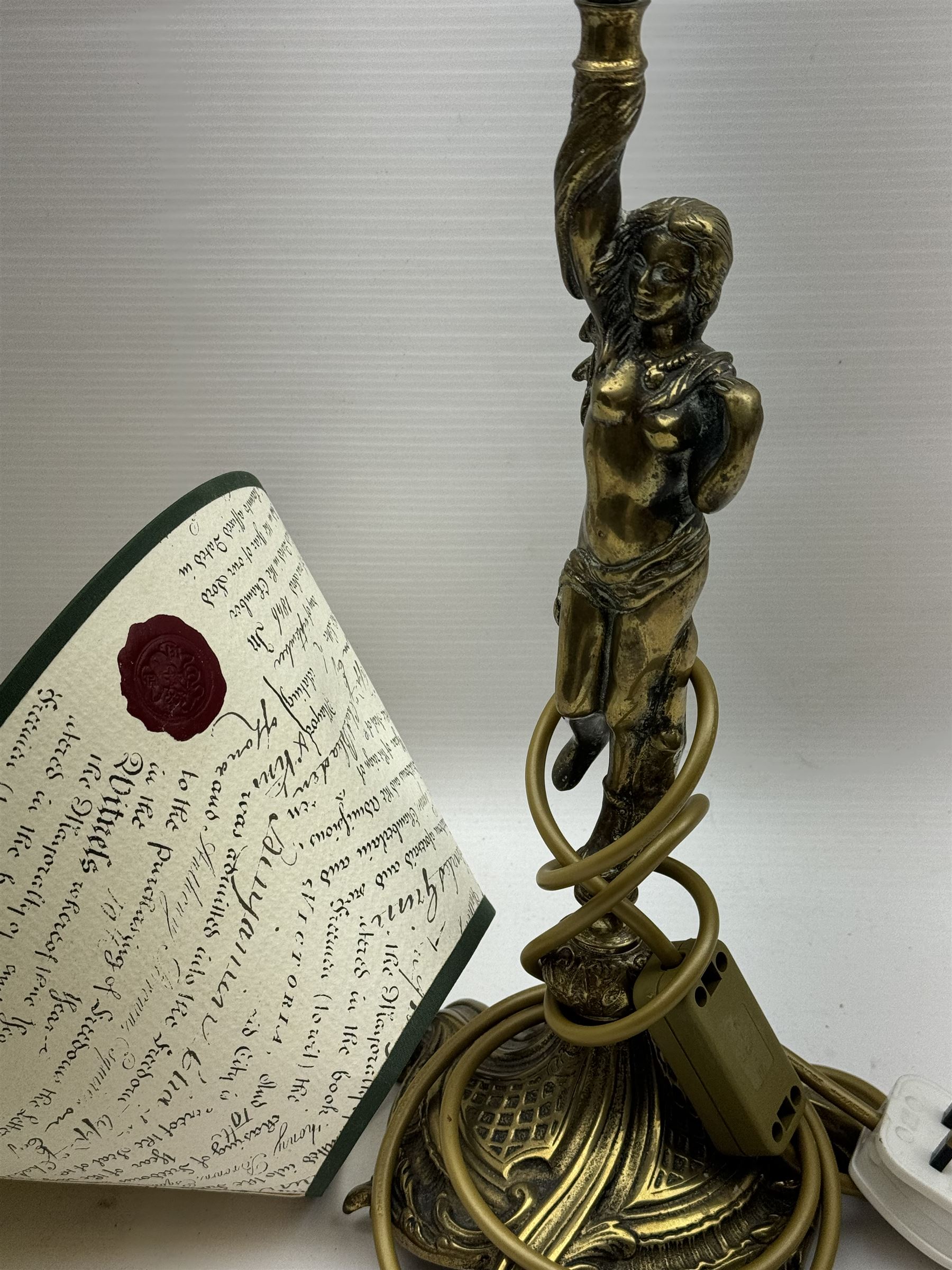 Gilt metal table lamp, modelled as a classical female figure holding the shade aloft in one hand, upon a spreading base, including shade H51cm