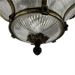 Edwardian brass ceiling light of circular bulbous form, moulded upper band over a guilloche cast central band united by shaped strapping, decorated with fruiting foliage festoons, fitted with frosted and vertical bevelled glass bowl, acanthus cast finial 