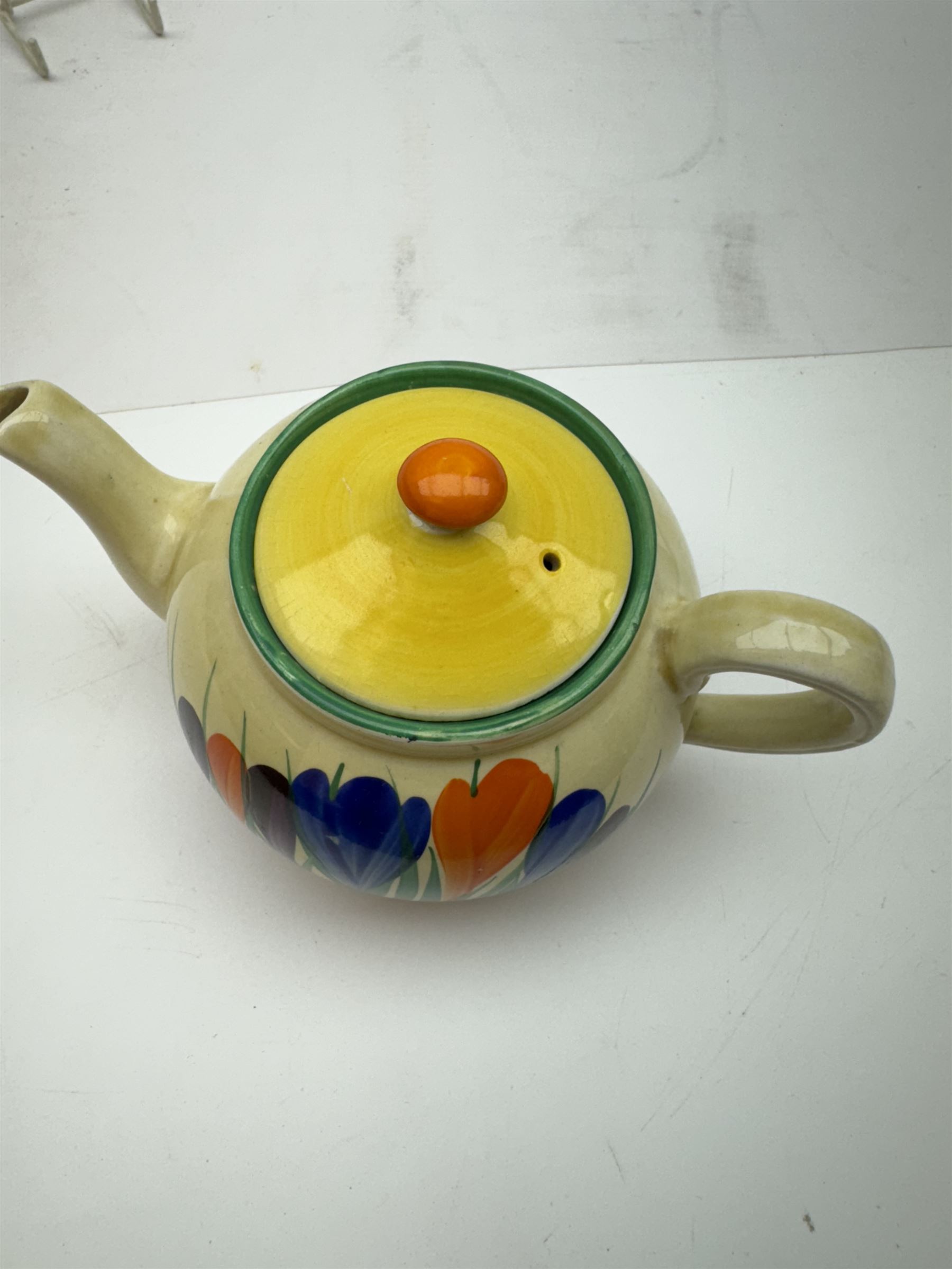 Clarice Cliff Bizarre 'Crocus' pattern teapot, H10cm, together with a Clarice Cliff Bizarre 'Crocus' pattern plate, D23cm, each with Crocus and Bizarre marks beneath, (2)