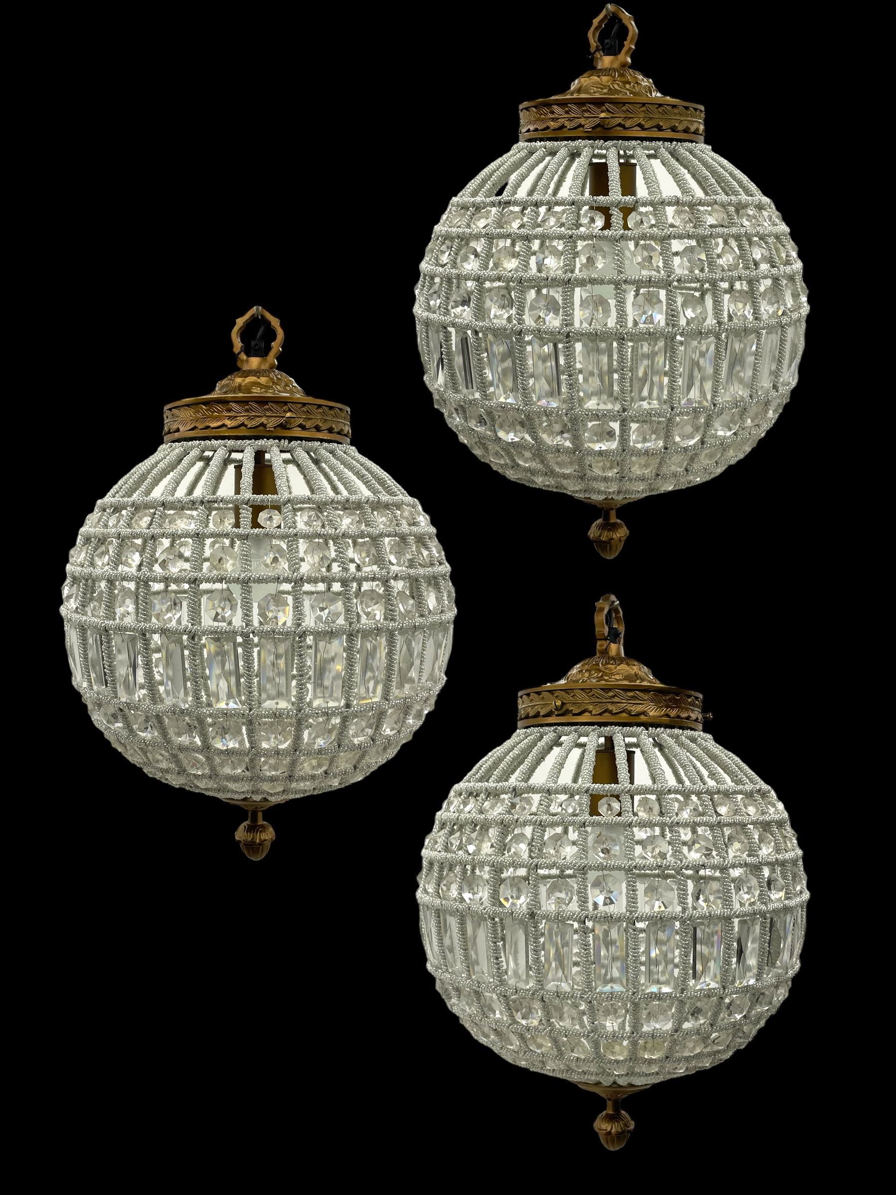 India Jane Interiors - set of three gilt metal and glass spherical ceiling light pendants, decorated with glass beads and pendants, foliage cast metal upper band, mounted by lower finial - ex-display/bankruptcy stock 