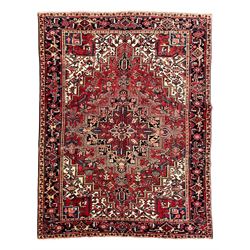 Persian Heriz red ground rug, overall geometric design, central medallion surrounded by st...