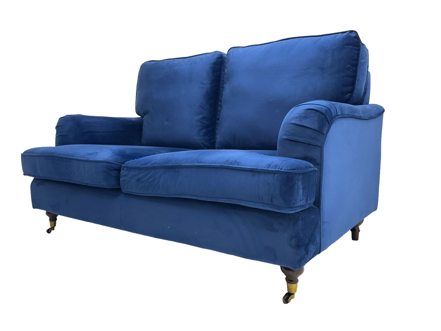 Howard design - two-seat sofa upholstered in blue fabric, traditional shape with rolled arms, on walnut finish turned feet with brushed metal cups and castors