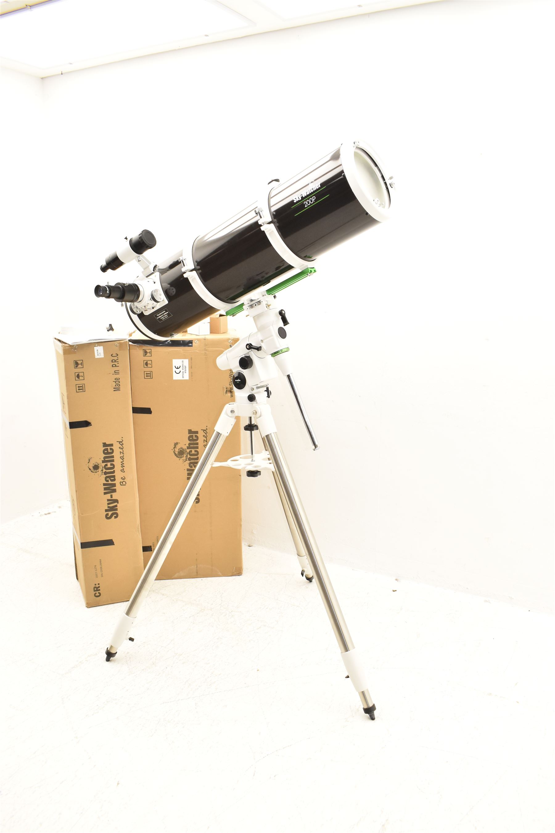 Sky Watcher 200P Newtonian 10” reflector telescope, NEQ3 tripod with counter weights, equatorial mount and finder scope, with a basic 1.25” smartphone adapter and accessories including a Super 10 long eye relief , Celestron 10mm lens, 2 x 1. Barlow lens and super 25 wide angle long eye relief lens. With assembly instruction manual and astronomical telescope user guide.