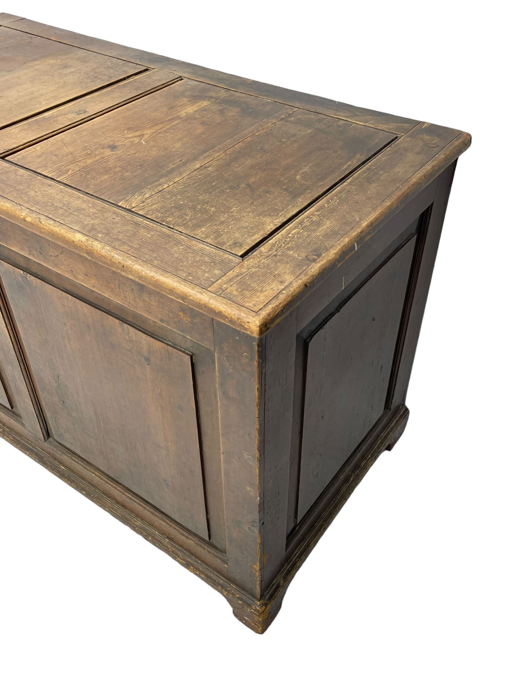 19th century pine blanket chest, double panelled hinged lid over panelled front and sides, on bracket feet