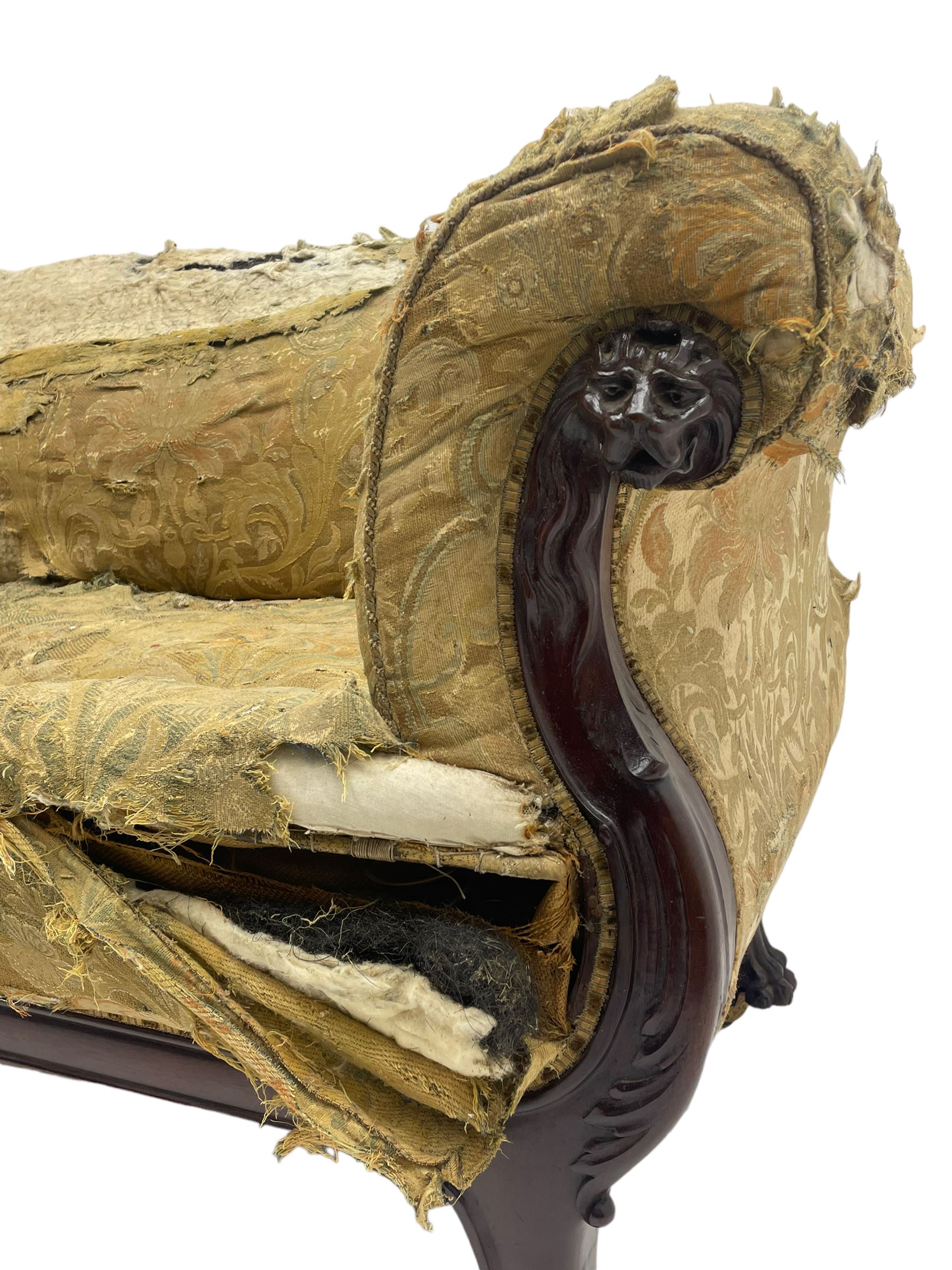 19th century mahogany settee, rolled S-scrolled arms carved with lion masks and acanthus leaf scrolls, the lower moulded rail carved with scrolling design, raised on carved paw feet with recessed brass and ceramic castors 