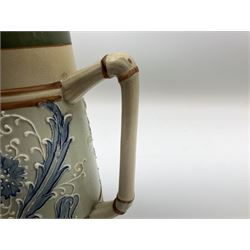 James Macintyre 'Gesso Faience' jug decorated with tubelined flowers and scrolling foliage in tones of blue against a pale green ground, printed mark beneath, H17cm