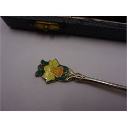 Set of six silver coffee spoons, each with enamelled daffodil decoration to terminal, hallmarked Turner & Simpson Ltd, Birmingham 1938, contained within fitted case