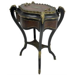 Late Victorian ebonised and amboyna wood jardinière planter, shaped form with removable lid inlaid with scrolling brass work and mounted by ornate cast gilt metal handles, the frieze rails inlaid with amboyna panels and brass stringing, on cabriole supports united by under-tier, decorated with cast gilt metal acanthus leaves and hooved feet caps