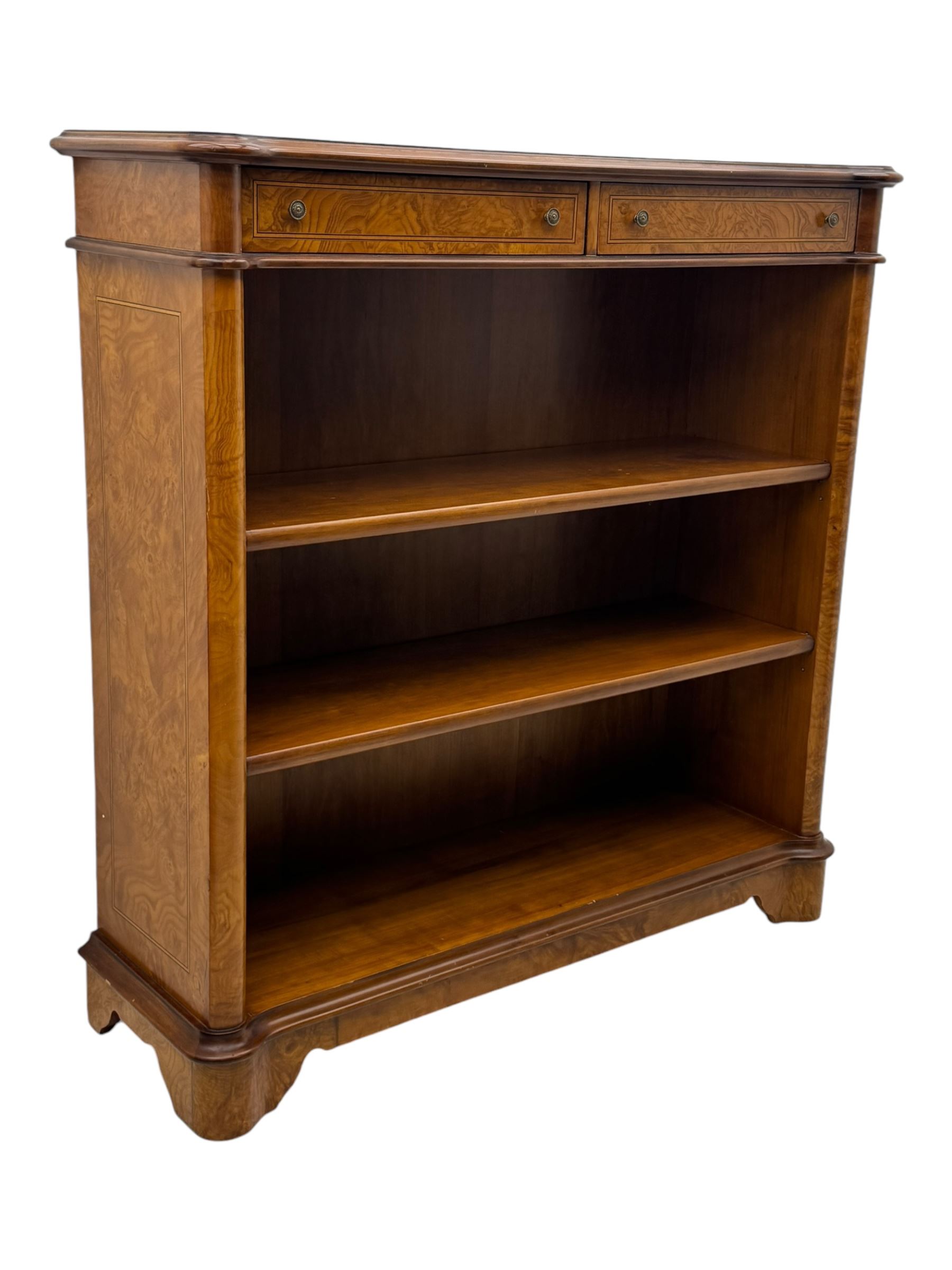 Figured walnut open bookcase, moulded top over two drawers and two shelves, on plinth base 