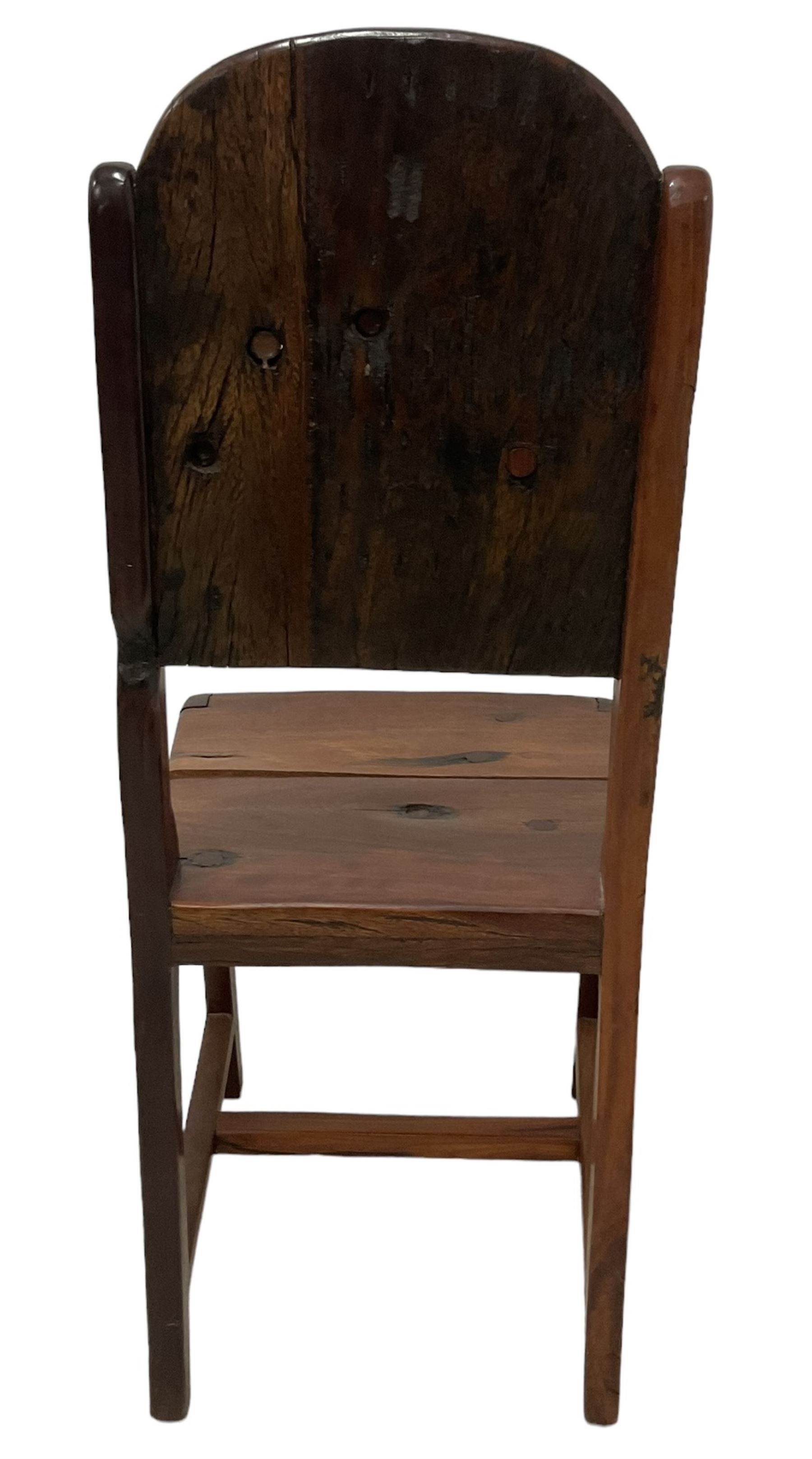 Mid-to-late 20th century teak dining table, rectangular top with canted corners, on square tapering supports with spade feet (214cm x 119cm, H76cm); and a set of eight Burmese reclaimed teak dining chairs, high arched back over panelled seat