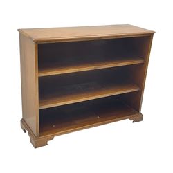 20th century mahogany open bookcase, fitted with two shelves, on bracket feet