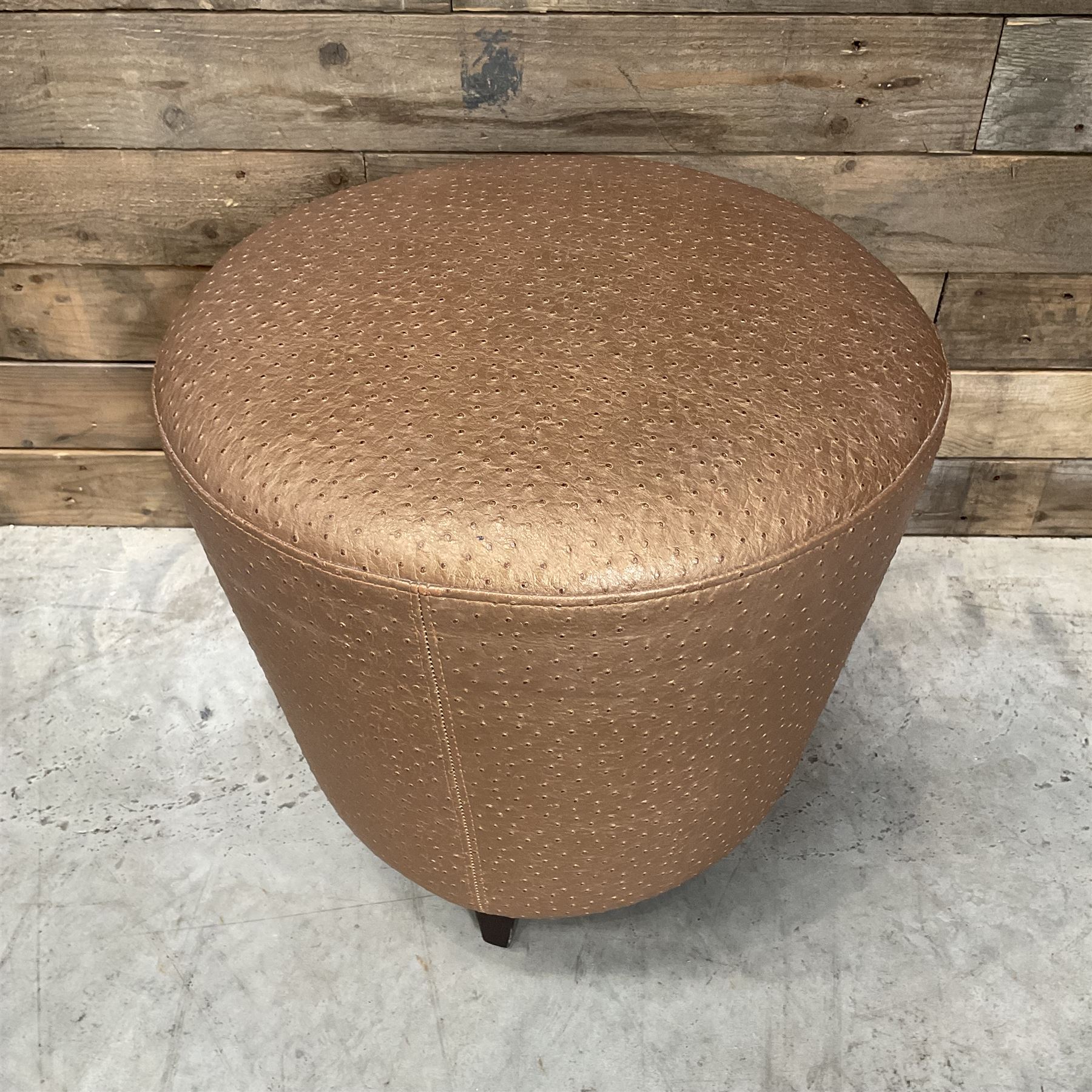 Four circular tapered stools, upholstered in gold fabric