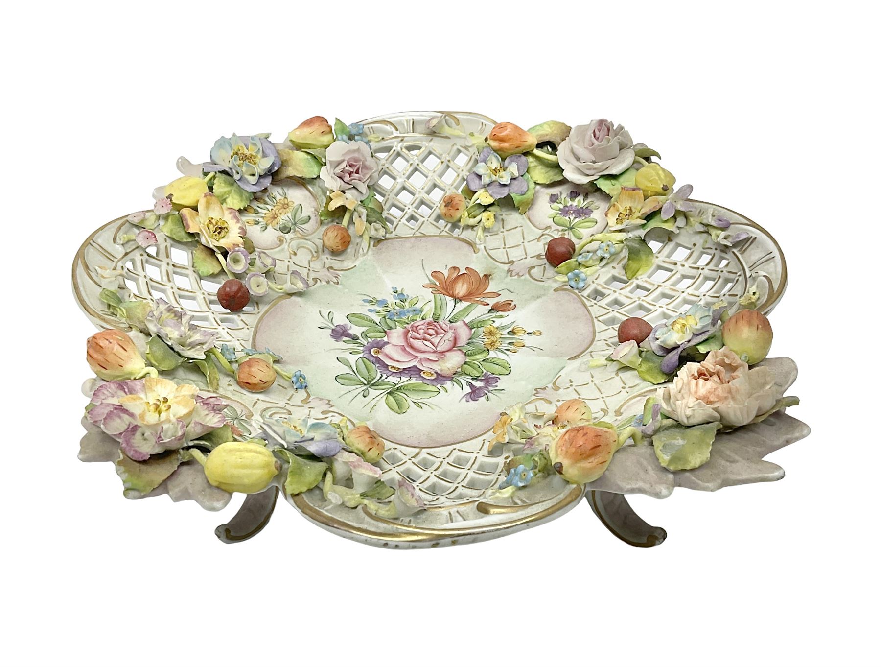 19th Meissen style centrepiece, with pierced lattice work sides and decorated in relief with fruit and floral sprigs, upon four scrolled feet, with spurious mark beneath H9cm D31cm