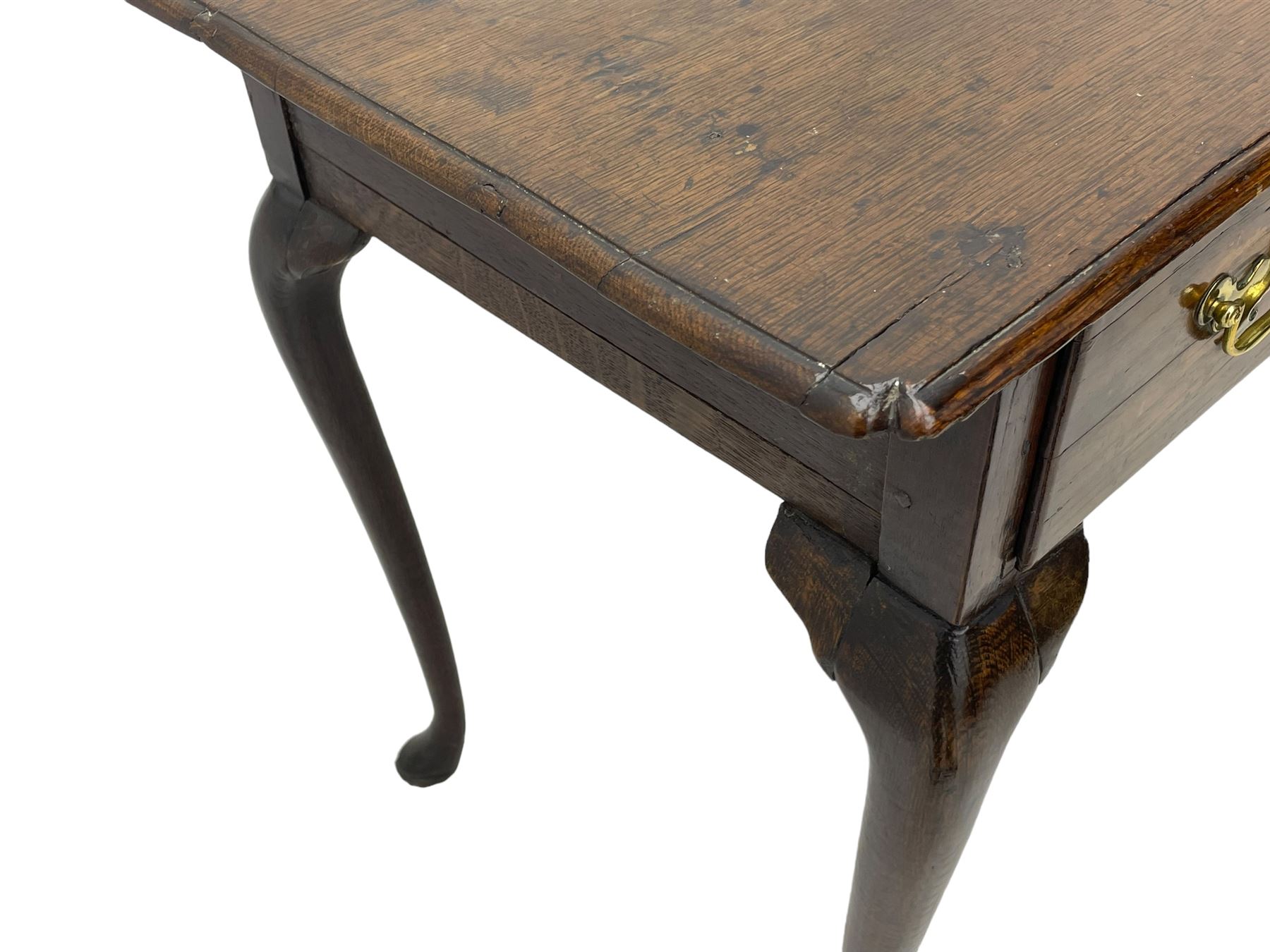 George III oak low-boy, moulded rectangular top with shaped corners, fitted with single drawer, shaped brass handle plates and escutcheon, on cabriole supports 