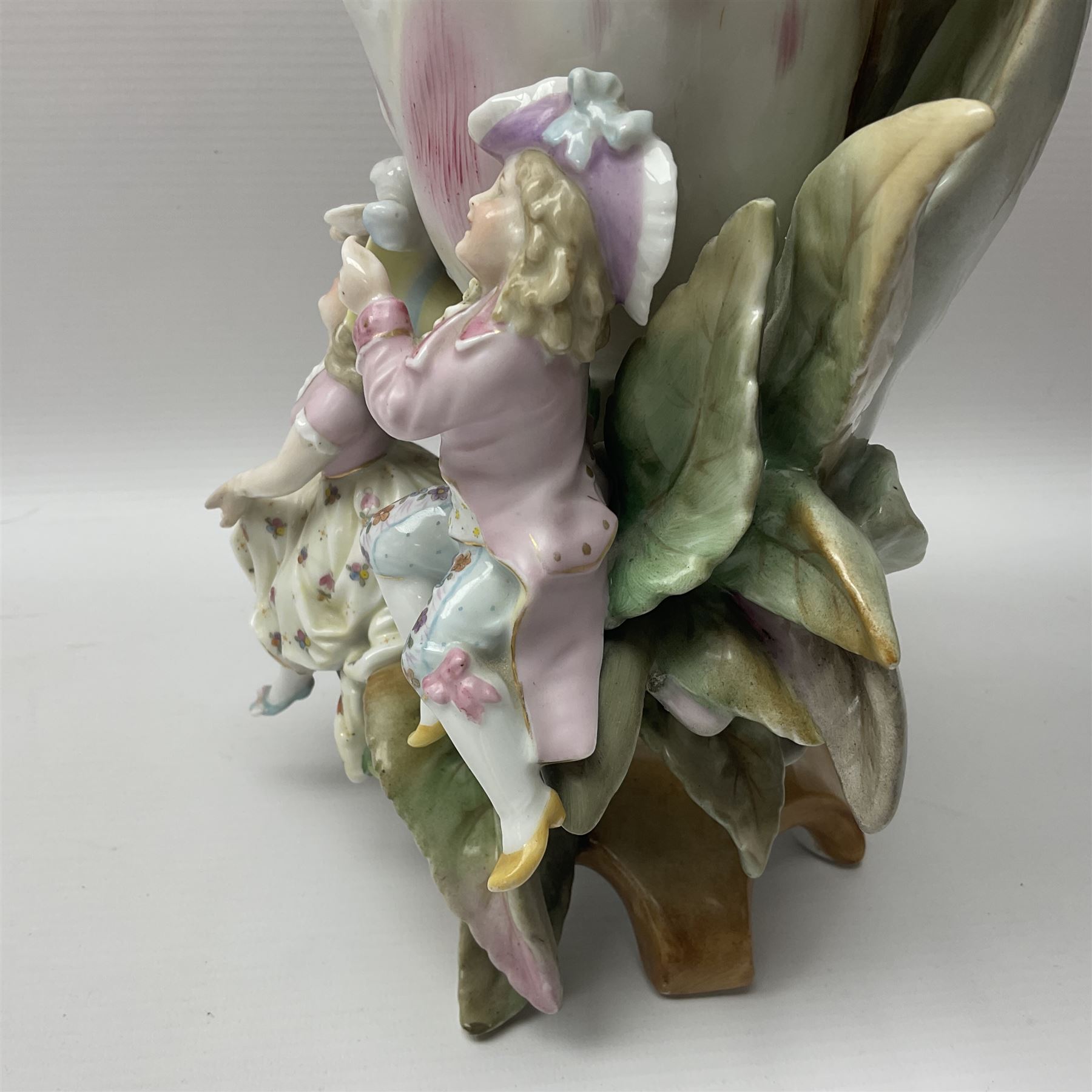 19th century Scheibe vase, modelled as a large open bud supported against and upon leaves on which perch three children in various poses, the whole upon feet modelled as leaves and branches, with blue KPM and cross mark beneath, H26cm