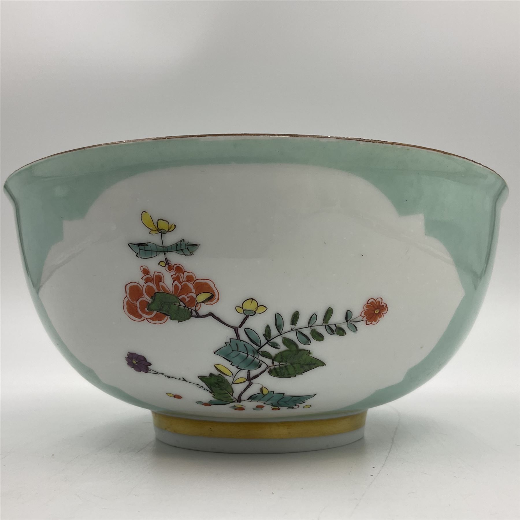 18th century Meissen turquoise ground bowl, circa 1740, decorated with two shaped reserves painted with Kakiemon type flowers, with gilt rim and band to short circular foot, with undergaze blue crossed swords mark to base, H7cm D15.5cm