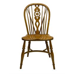 Set of four elm Windsor dining chairs, hoop and stick back with shaped wheel splat, dished seat on turned supports united by crinoline stretcher 