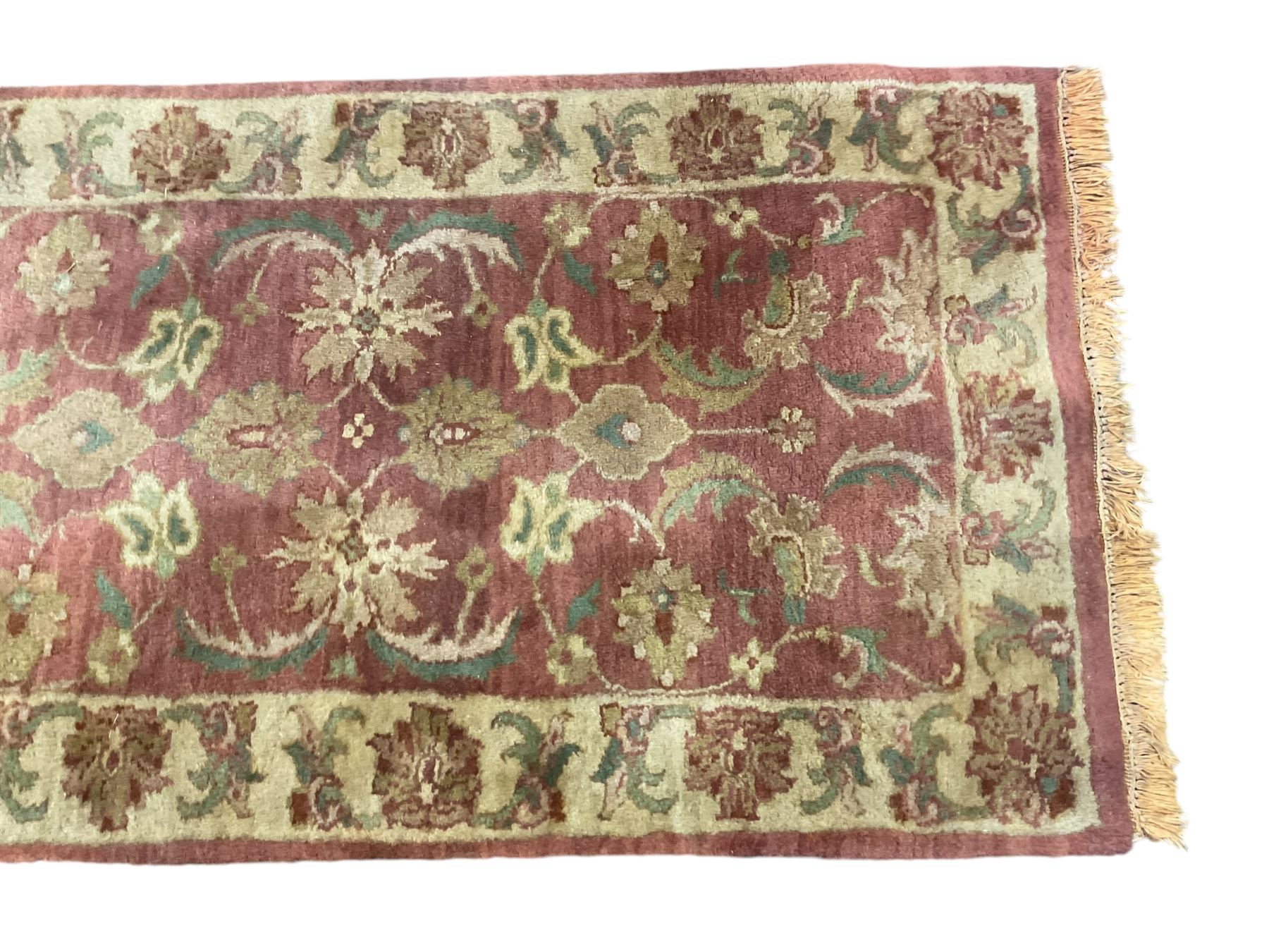 Persian Zeigler crimson ground runner rug, field decorated with scrolling foliate patterns with palmette motifs, enclosed by a camel guard band with further floral designs