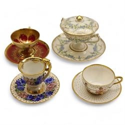 Four early 19th century Dresden cups and saucers, comprising twin handled chocolate cup an...