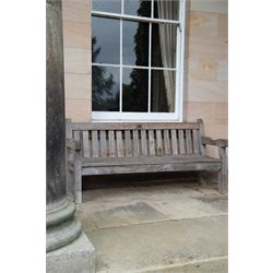 'J.V.T. Ampleforth' - teak garden bench, plain cresting rail with applied maker's plaque over slatted back and seat, on square supports 