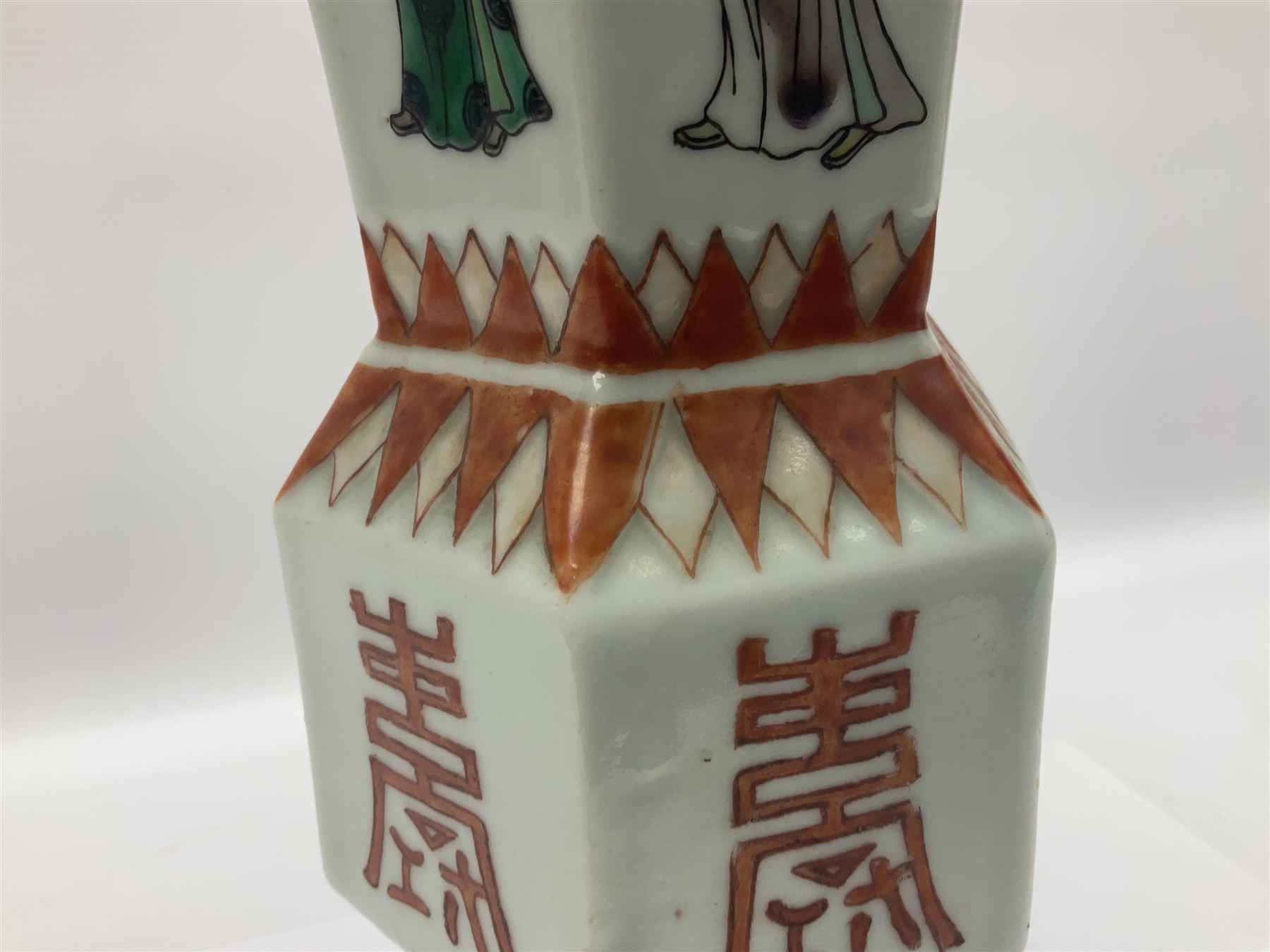 Chinese Kangxi gu vase, of hexagonal form with fluted rim, decorated in polychrome enamels with a male figure to each panel and red character marks to centre, with painted red leaf mark beneath, H32.5cm