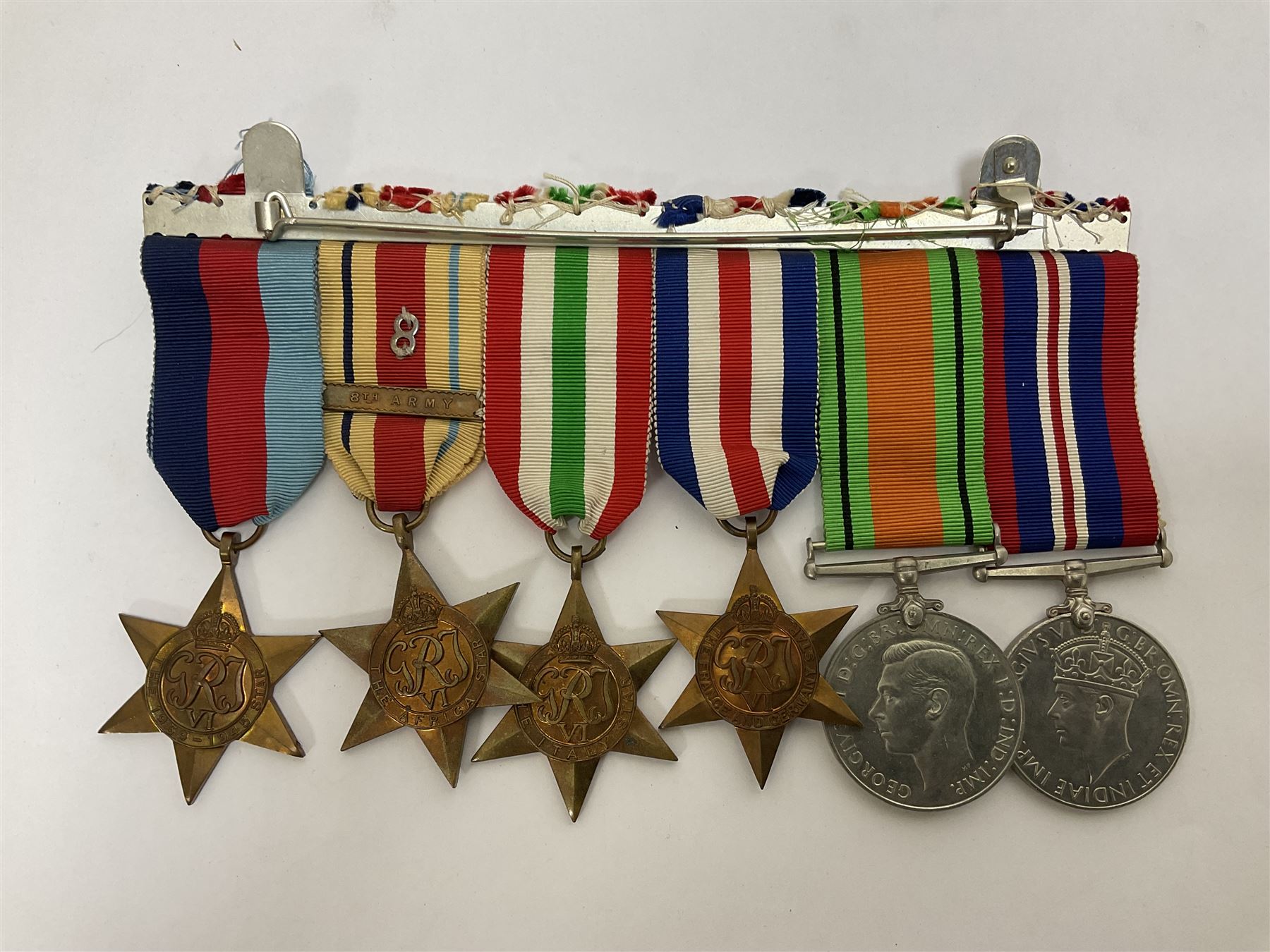 WWII group of six medals comprising 1939-45 Star, The Africa Star, The Italy Star, France and Germany Star, Defence Medal and War Medal 1939-45, awarded to 7899181 RAC C.W Hughes, together with two chevrons and ephemera relating to Charles William 'Bill' Hughes including Soldier's Release Book, photographs, certificates of transfers etc 