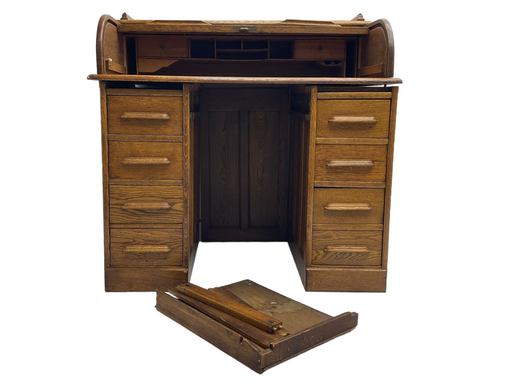 Early 20th century oak twin pedestal desk, tambour roll top enclosing fitted interior, eight drawers, on plinth base