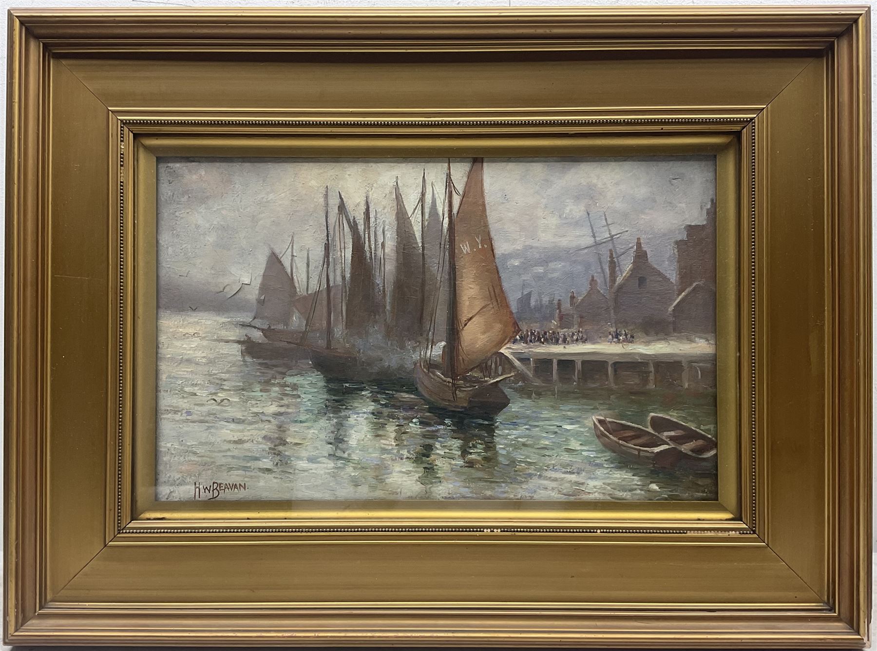 H W Beavan (British Early 20th century): Sailing Boats Moored in Whitby Harbour and Angler on Whitby Shore, pair oils on canvas signed one dated '08, 24cm x 39cm (2)