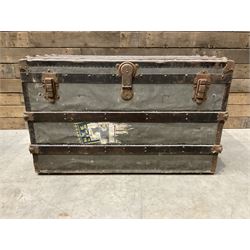 Early 20th century wood and metal bound zinc travelling trunk, hinged top with three clasp...