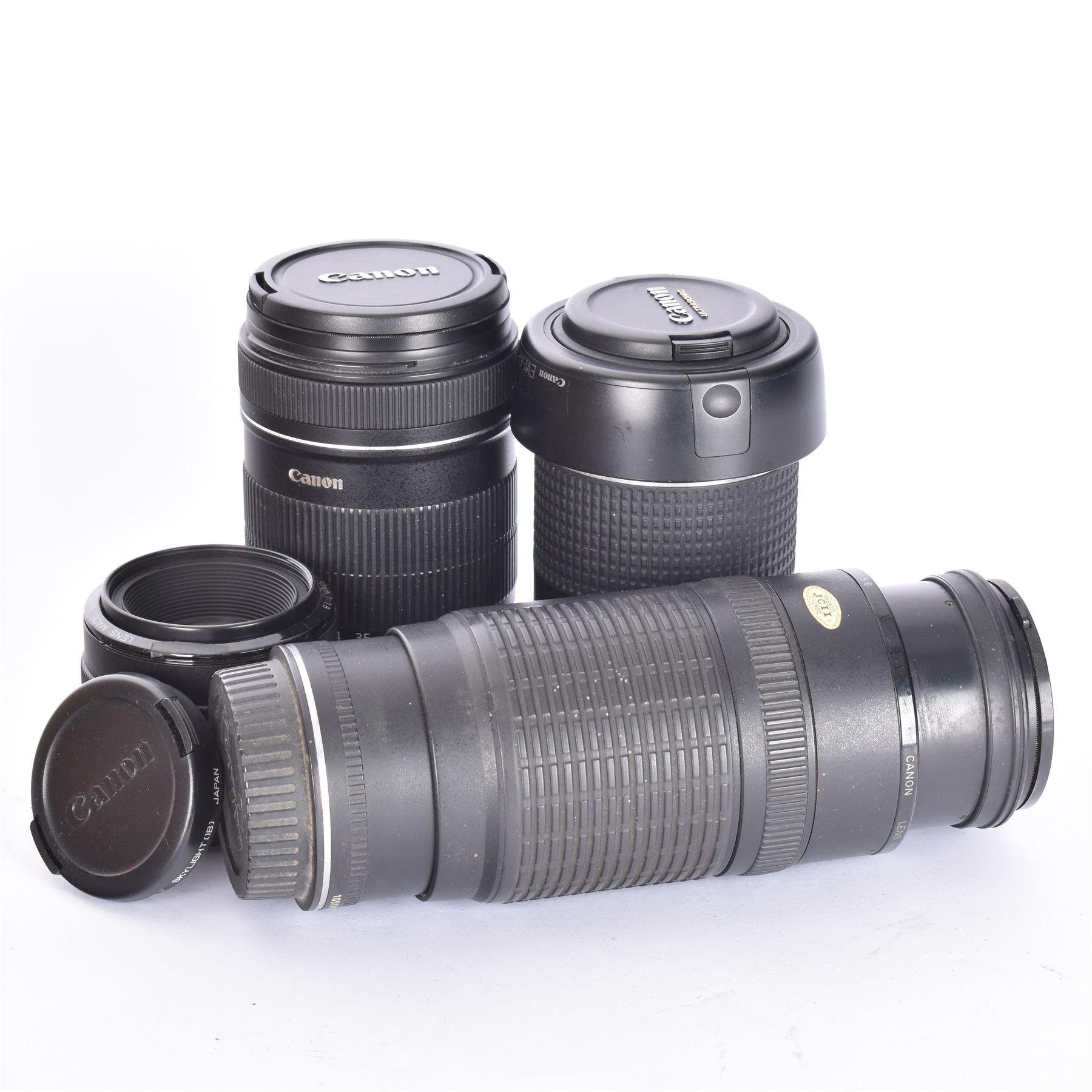 Three Canon EF camera lenses, comprising 100-300mm 1:5.6 lens serial no. 1057918, 50mm 1-1.8 lens serial no. 1153183 and a 55-200mm 1:4.5-5.6 USM zoom lens serial no. 2100282B, together with a Canon EF-S 18-135mm 1:3.5-5.6 image stabiliser lens serial no. 7242517341