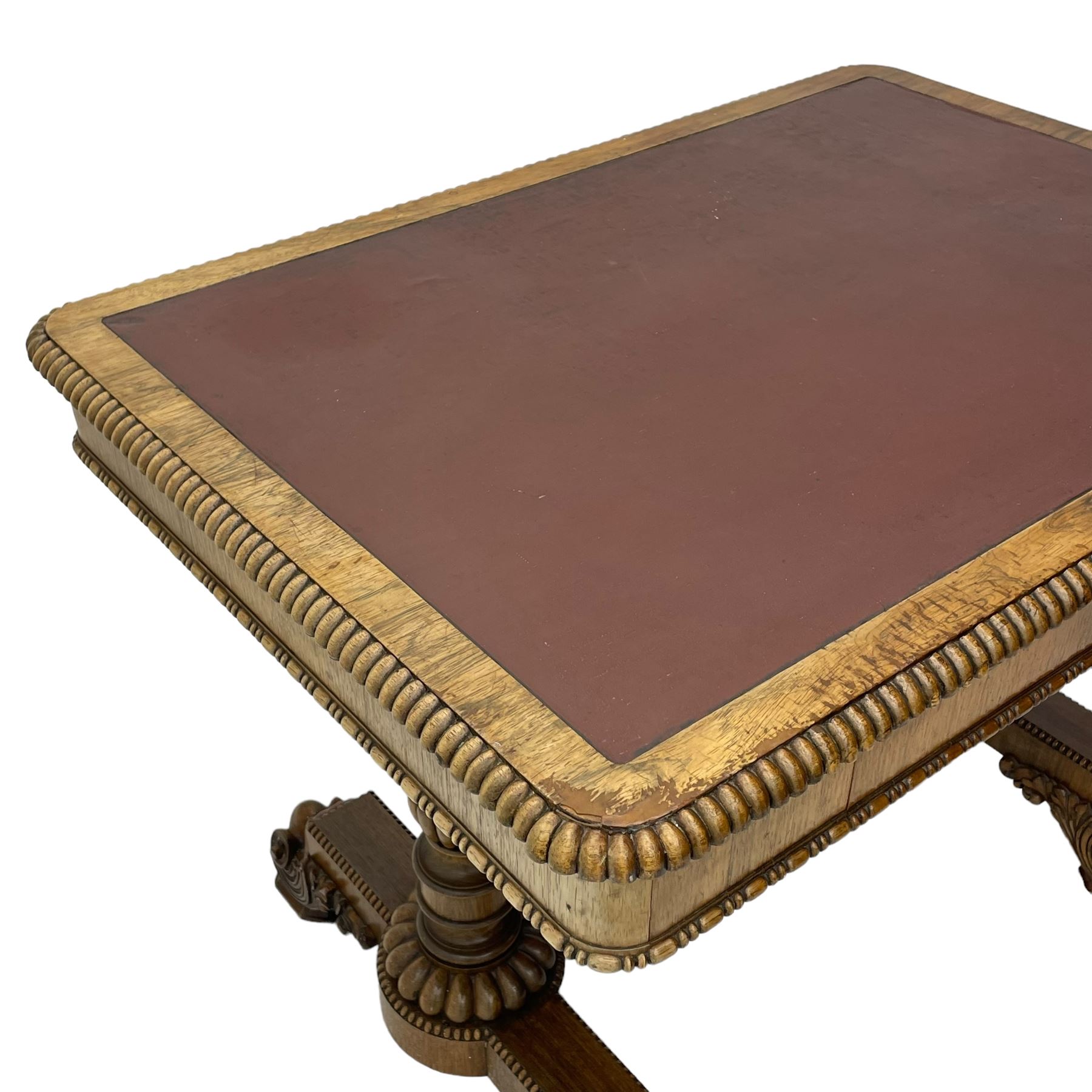 Early 19th century Regency rosewood writing table, rectangular top with inset leather writing surface and gadroon moulded edge, fitted with single frieze drawer, on twin turned pillar supports with lobe carved balusters, on platforms with beaded edge, acanthus scroll carved feet