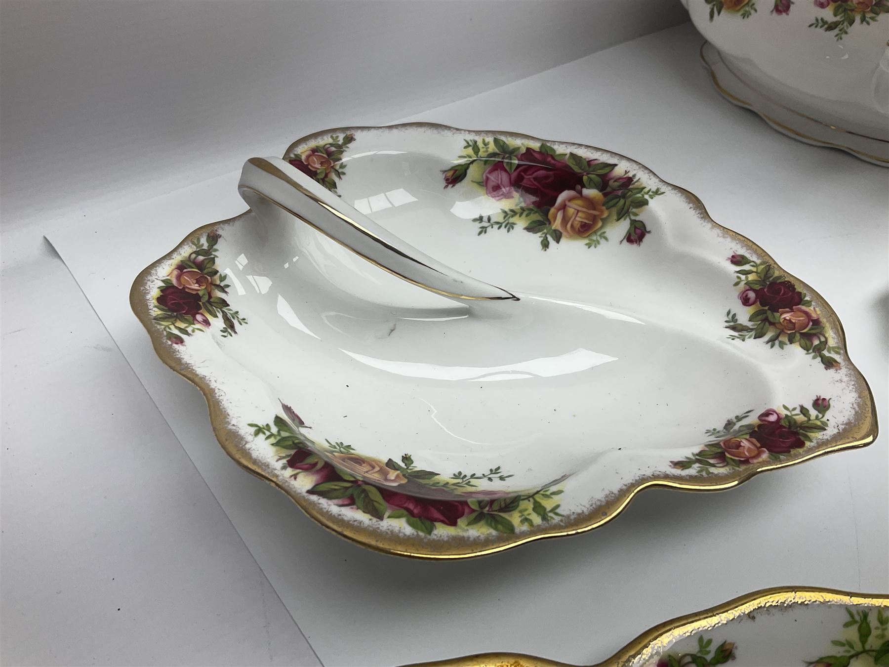 Royal Albert Old Country Roses pattern part tea and dinner service, to include two tureens, eight dinner plates, six side plates, twelve bowls, two mugs, seven teacups and saucers, milk jug,  twelve cake plates, six soup bowls and saucers, candlesticks, etc (95)