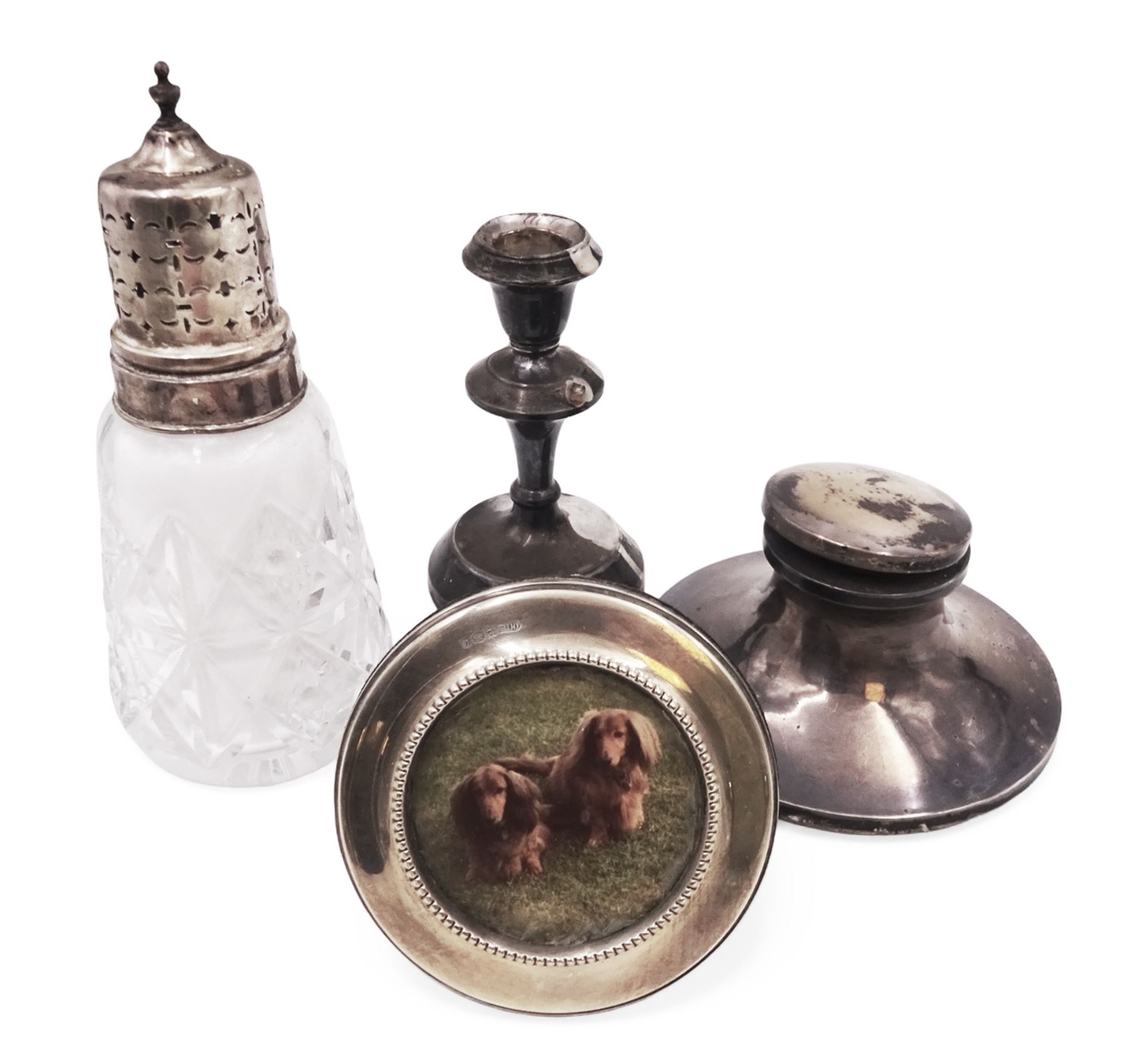 Group of silver mounted items, including cut glass sugar caster, capstan inkwell, circular photograph frame and dwarf candlestick, candlestick H11cm