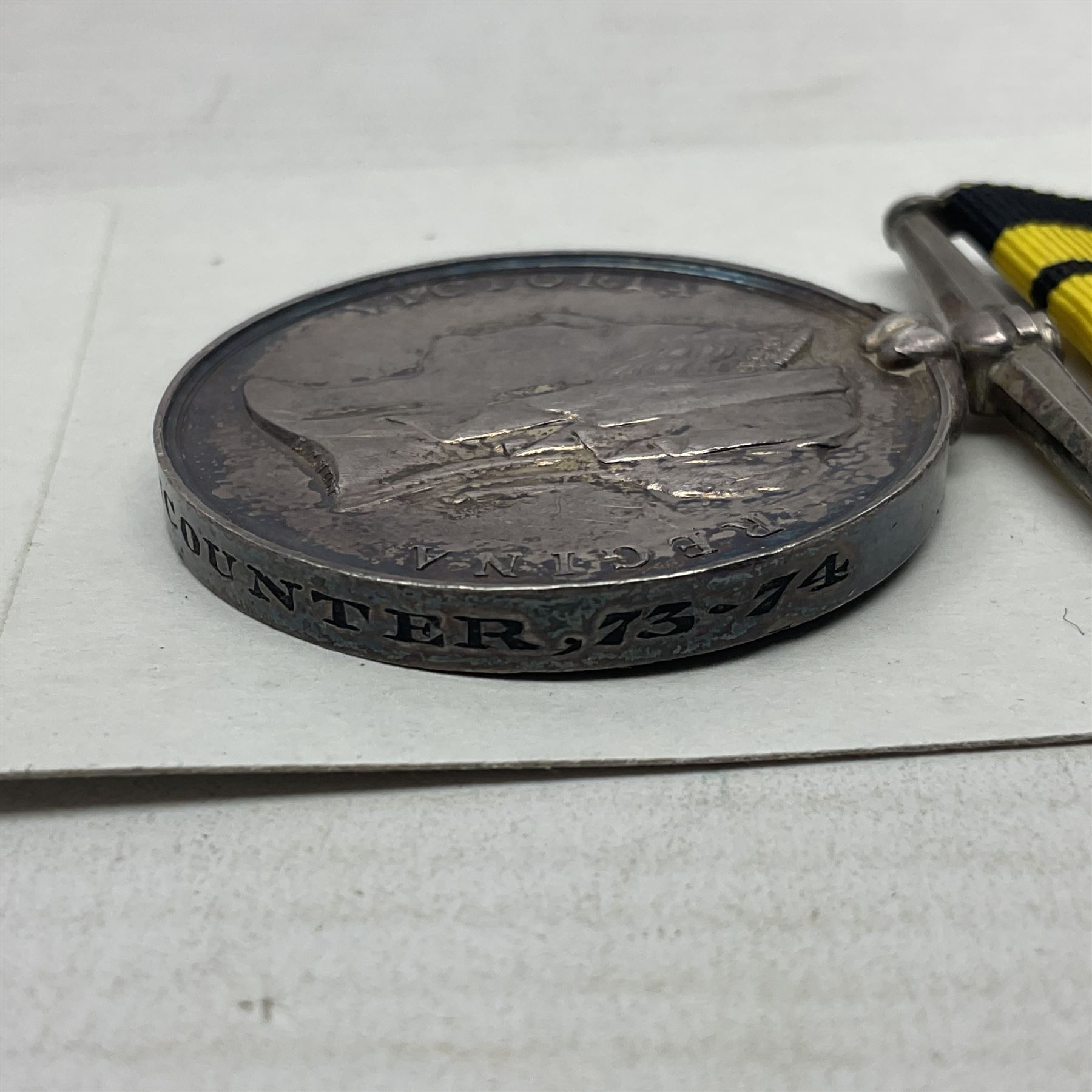 Victoria Ashantee Medal 1887-1900 awarded to W. Gray Ord. H.M.S. Encounter 73-74; with replacement ribbon but original present.