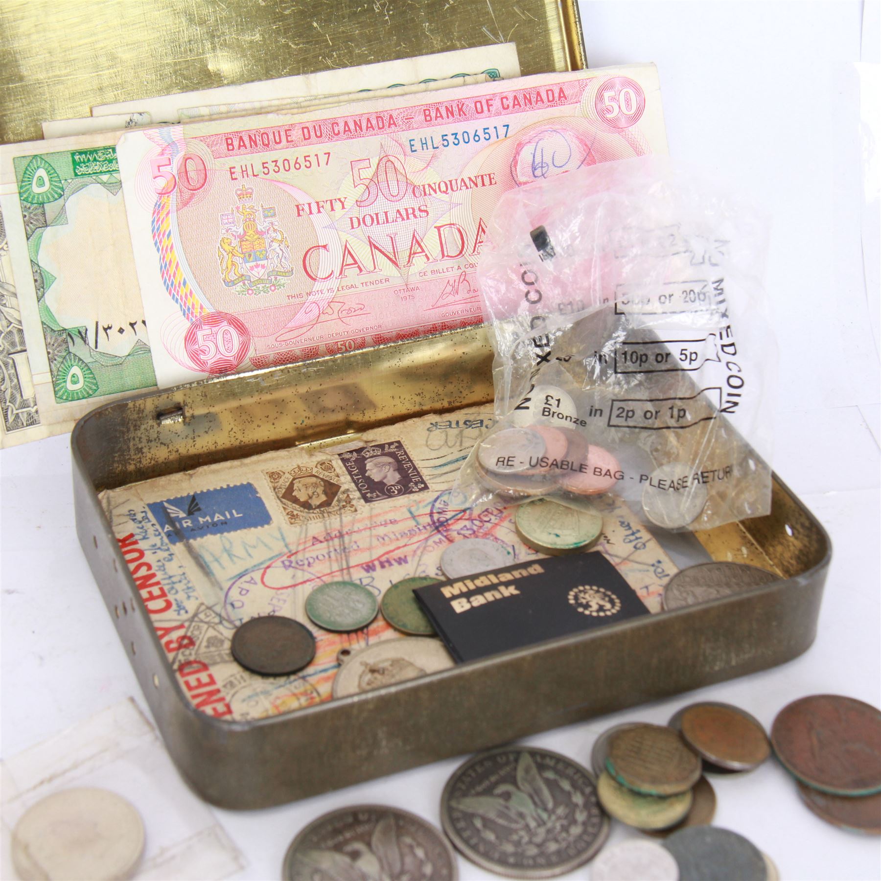 Various coins and banknotes including two Morgan dollars, in a vintage tin