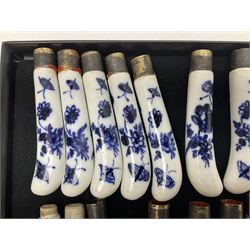 Collection of 18th century blue and white porcelain pistol grip knife hafts, possibly Worcester, comprising set of twenty one decorated in the same pattern with floral sprays and butterflies, with gilt mounts, and a further three with varied decoration of flowers and insects, each approximately L10cm