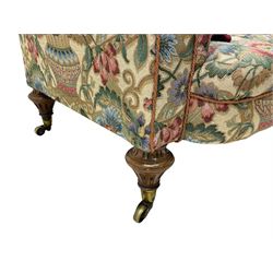 Mid-19th century walnut framed two-seat sofa, rolled arms over sprung seat, single drop-end action, raised on turned and fluted feet with brass cups and castors, upholstered by E & S Gott in traditional floral pattern fabric decorated with urns