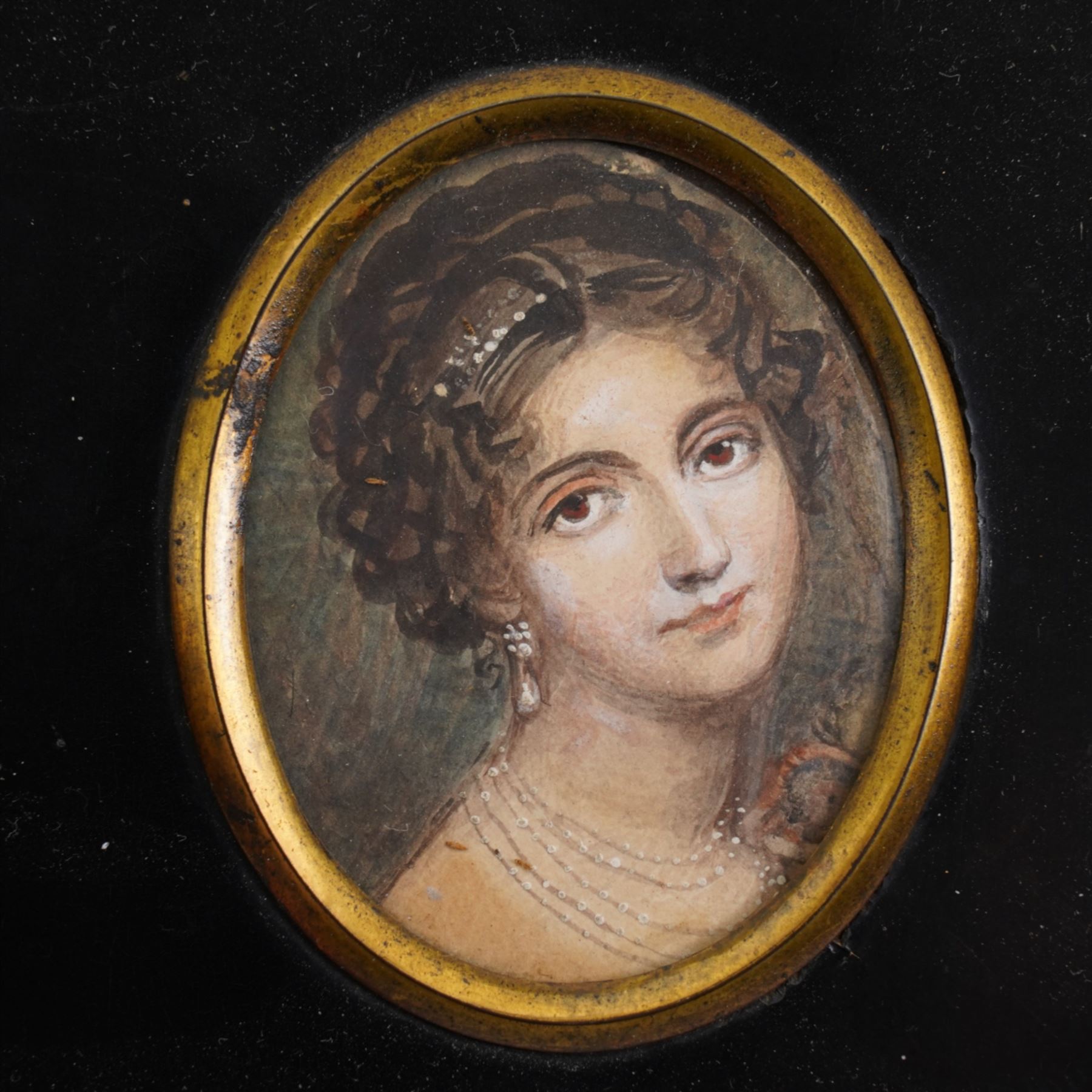 English School (19th century): Portrait of a Mediterranean Beauty with a Pearl Earring, miniature watercolour on paper unsigned 6cm x 5cm