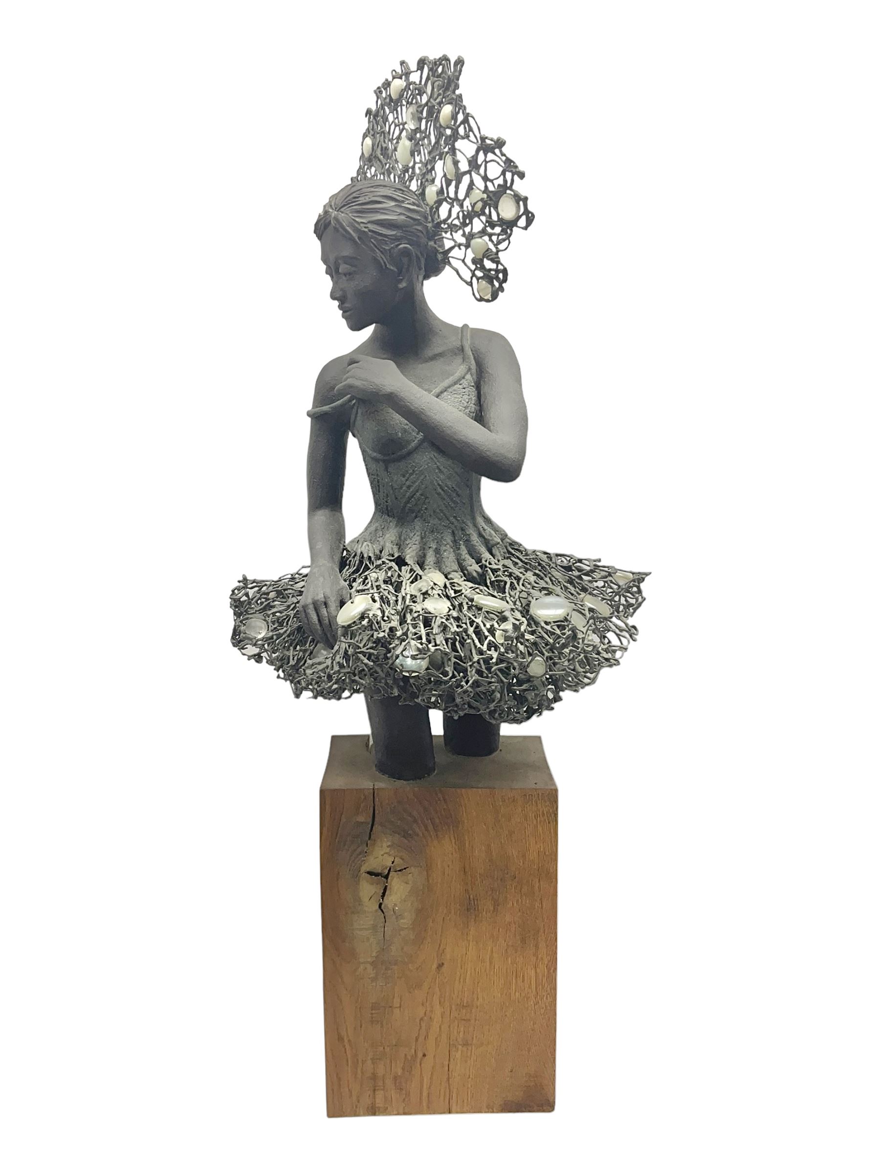 Composite bronzed sculpture, modelled as a ballerina, the skirt and head dress 
 set with glass cabochons, upon a rectangular wooden plinth, H92cm